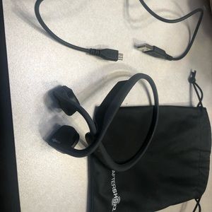 AfterShokz ear phones. Comes with charging cable. Bluetooth compatible.